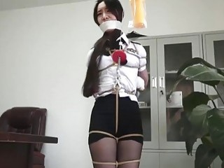 Asian chick is tied up completely and forced to struggle